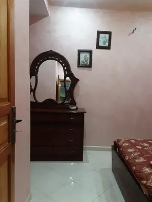 a bedroom with a dresser and a mirror on the wall at Appartement à louer à imouzzar kander in Imouzzer Kandar