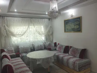 a living room with a couch and a table at Appartement à louer à imouzzar kander in Imouzzer Kandar