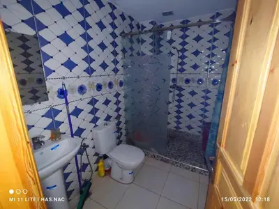 a bathroom with a shower and a toilet and a sink at Appartement à louer à imouzzar kander in Imouzzer Kandar