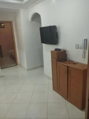 a room with a television on a wall with a tiled floor at Appartement à louer à imouzzar kander in Imouzzer Kandar