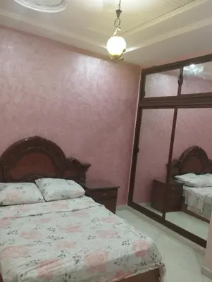a bedroom with a bed and a large window at Appartement à louer à imouzzar kander in Imouzzer Kandar