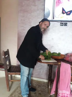 a man standing at a table with a plate of food at BRYKHOME in Fès
