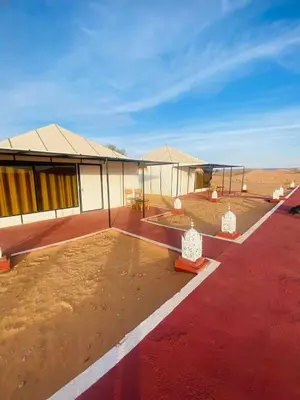 a building in the middle of the desert at sahara oasis camp in Merzouga
