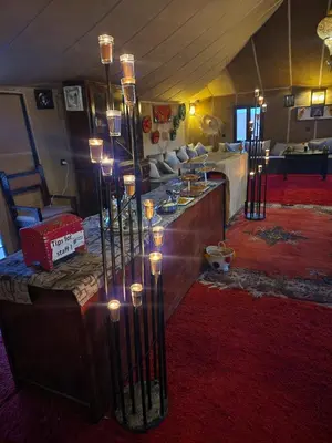 a living room with a table with candles on it at sahara oasis camp in Merzouga