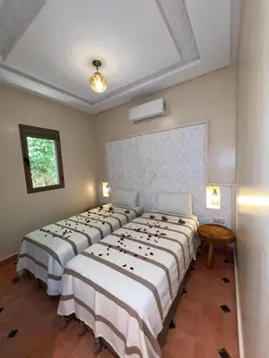 a row of beds in a room at Dar Fatima Tamazouzt in Marrakech