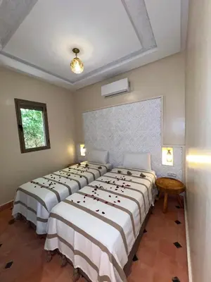 a row of beds in a room at Dar Fatima Tamazouzt in Marrakech