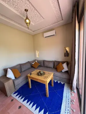 a living room with a couch and a table at Dar Fatima Tamazouzt in Marrakech