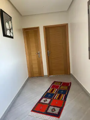 a room with two doors and a rug on the floor at Dar Fatima Tamazouzt in Marrakech