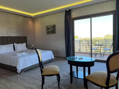 a hotel room with a bed and a balcony at Dar Fatima Tamazouzt in Marrakech