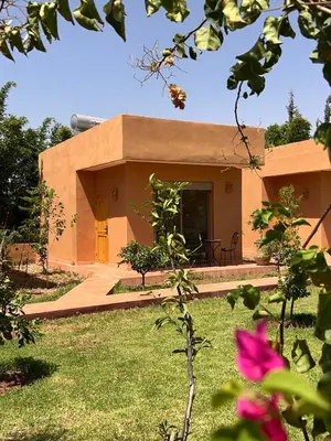 a building with a grassy yard in front of it at Dar Fatima Tamazouzt in Marrakech