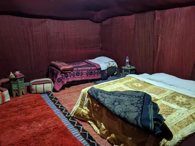 a bedroom with two beds in a room at Erg Chigaga Regency Camp in El Gouera