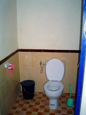 a small bathroom with a toilet in a stall at Chez Meriem in Merzouga
