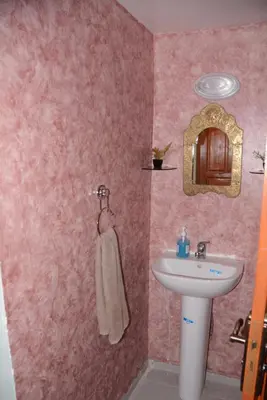 a small bathroom with a sink and a sink at Dar El Karam Fez in Fès