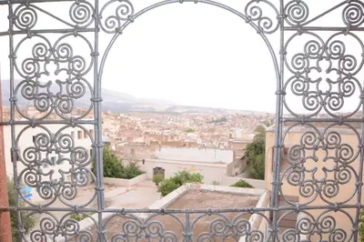 an iron gate with a view of a city at Dar El Karam Fez in Fès