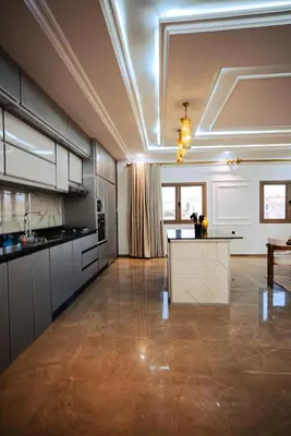 a large kitchen with a table in the middle of a room at Kasbah Merzouga in Merzouga