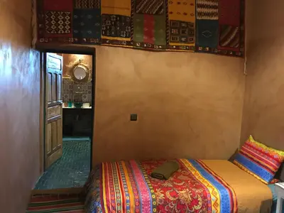a bedroom with a bed in a room at Kasbah Mashallah in Tagounite