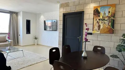 a living room with a table and a couch at Luxury appartement Fes in Fès