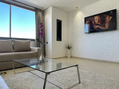 a living room with a couch and a glass table at Luxury appartement Fes in Fès