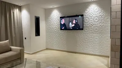 a living room with a couch and a picture on the wall at Luxury appartement Fes in Fès
