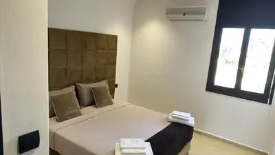 a bedroom with a large bed with a window at Luxury appartement Fes in Fès