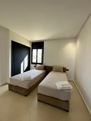 a bedroom with two beds and two windows at Luxury appartement Fes in Fès