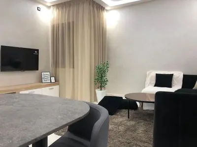 a living room with a couch and a table at Appart luxueux sécurisé parking 10 min Medina in Fès