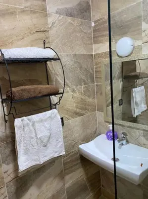 a bathroom with a sink and a toilet and a shower at Appart luxueux sécurisé parking 10 min Medina in Fès