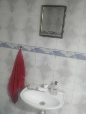 a bathroom with a white sink and a mirror at Magnifique appartement avec un bon emplacement in Fès