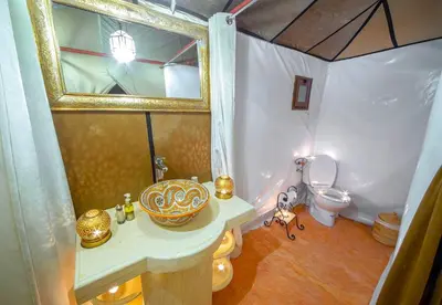 a bathroom with a sink and a toilet at Nomadic Sands Retreat in Merzouga