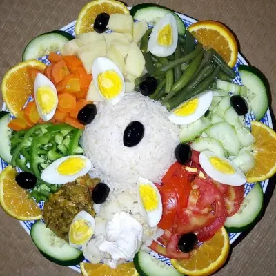 a plate of food with a teddy bear made out of food at Bivouac la fibule des Dunes in Merzouga