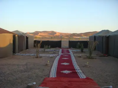 a red carpet in the middle of the desert at Bivouac la fibule des Dunes in Merzouga