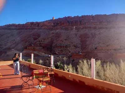 a woman taking a picture of the grand canyon at Pergolas Tamakouchte in Ouarzazate