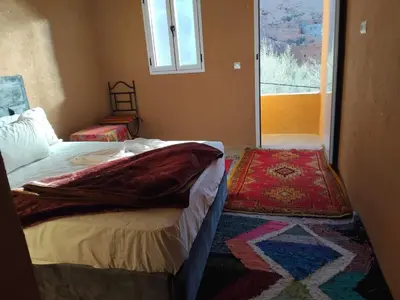 a bedroom with two beds and a window at Pergolas Tamakouchte in Ouarzazate
