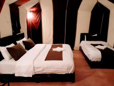 a hotel room with two beds in a room at Luxury Desert Camp Merzouga in Merzouga