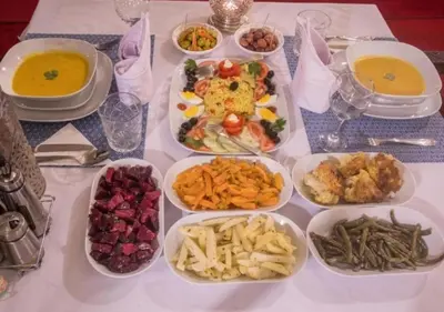a table topped with plates of food and bowls of food at Luxury Desert Camp Merzouga in Merzouga