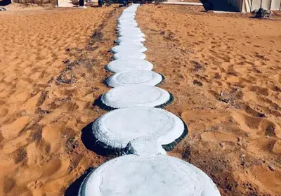 a row of white rocks in the sand at Glamping luxury camp in Merzouga