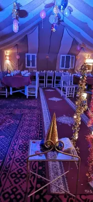 a room with a table with a pair of glasses on it at Chez Sadoq Luxury Camp in Merzouga