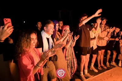a group of people standing in front of a crowd at Chez Sadoq Luxury Camp in Merzouga