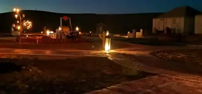 a street at night with lights on the road at Chez Sadoq Luxury Camp in Merzouga