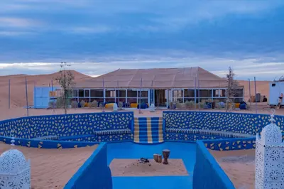 a building in the middle of the desert at Chez Sadoq Luxury Camp in Merzouga