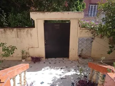 a black door in a building with at Rez-de-chaussée villa touta in Beni Mellal