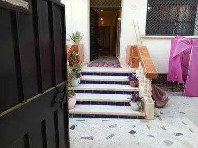 a stairway leading to a house with potted plants at Rez-de-chaussée villa touta in Beni Mellal