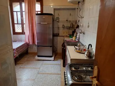 a kitchen with a refrigerator and a stove in it at Rez-de-chaussée villa touta in Beni Mellal