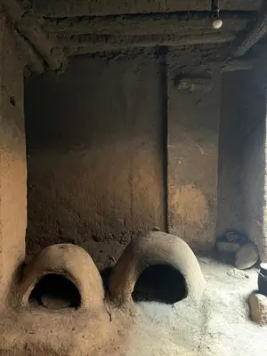 a stone oven with two holes in the wall at Dar Nuyum in Bou Nou