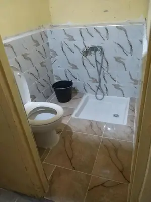 a bathroom with a toilet and a shower in it at Dar Nuyum in Bou Nou