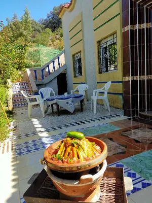 a bowl of food in front of a house at Gîte tazekka in Taza