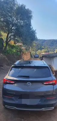 a blue car parked on a dirt road at Gîte tazekka in Taza