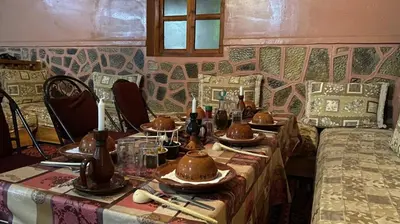 a dining room with a table with hats on it at Riad Bouchahoud Hotel in Telouet in Telouet