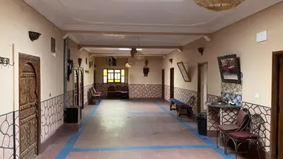 a hallway of a building with chairs and tables at Riad Bouchahoud Hotel in Telouet in Telouet