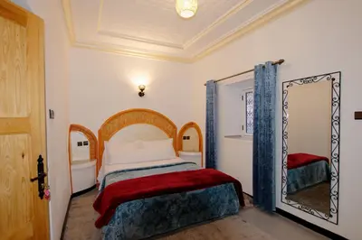 a bedroom with a bed and a mirror at RIAD dreams dades in Tamellalt